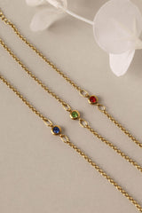 Dainty 18k gold-plated stainless steel birthstone bracelet with a single bezel-set gemstone, symbolizing personal meaning and everyday elegance.