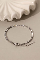 Skinny 2.5mm stainless steel tennis bracelet with sparkling stones, waterproof design, casual yet elegant, paired with matching necklace.