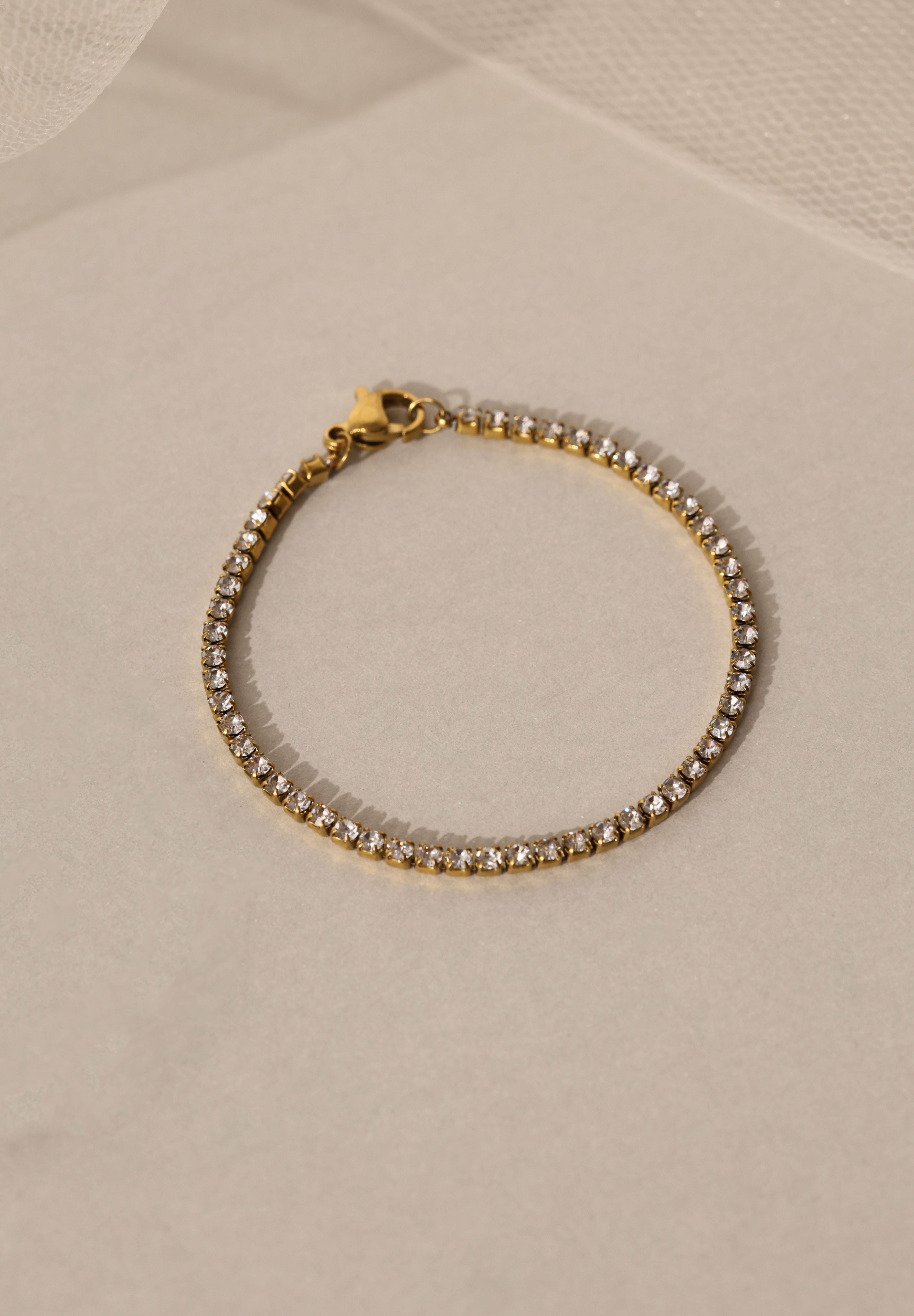 Skinny 2.5mm stainless steel tennis bracelet with sparkling stones, waterproof design, casual yet elegant, paired with matching necklace.