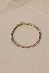 Skinny 2.5mm stainless steel tennis bracelet with sparkling stones, waterproof design, casual yet elegant, paired with matching necklace.