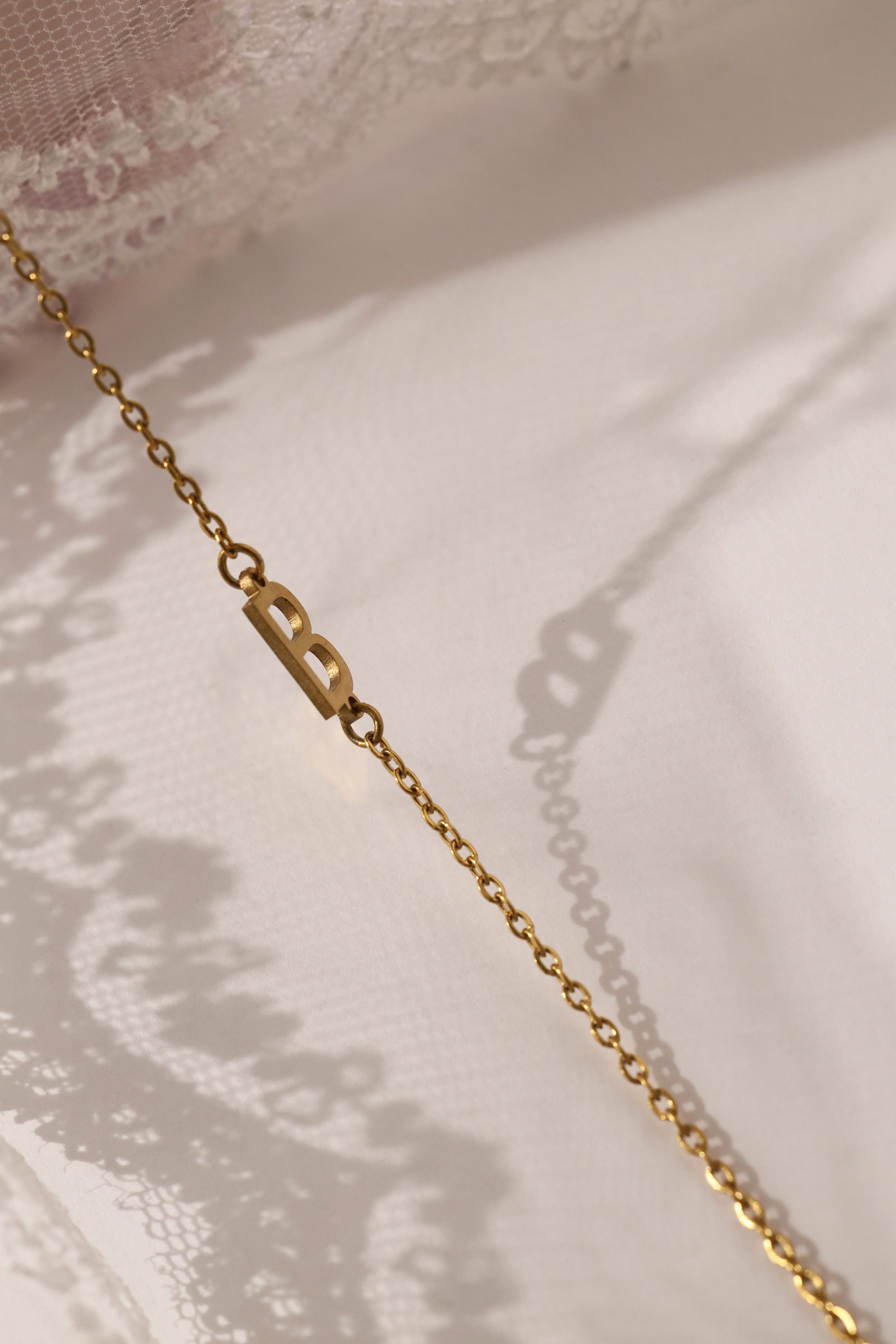 Stainless steel initial bracelet with sleek letter charm, delicate chain, minimalist look, waterproof and tarnish‑resistant