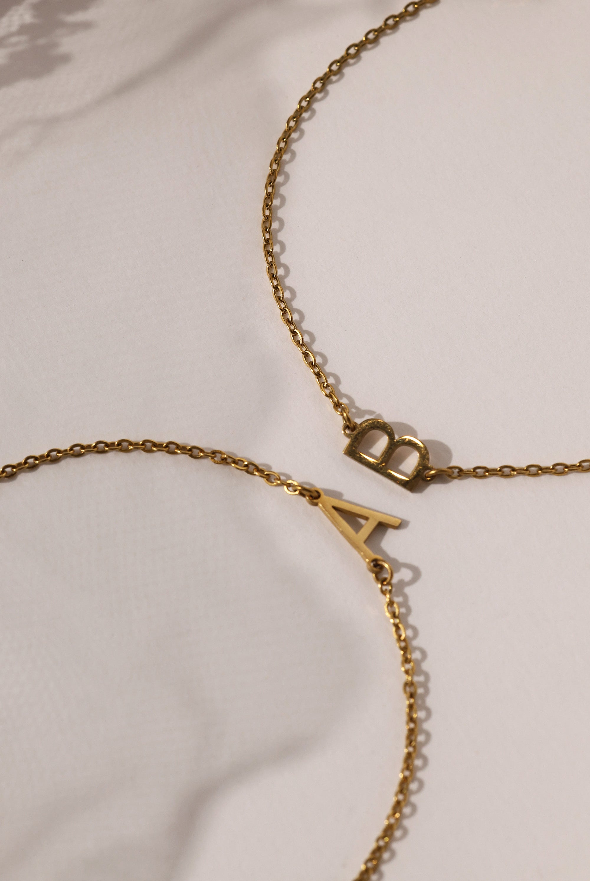 Stainless steel initial bracelet with sleek letter charm, delicate chain, minimalist look, waterproof and tarnish‑resistant