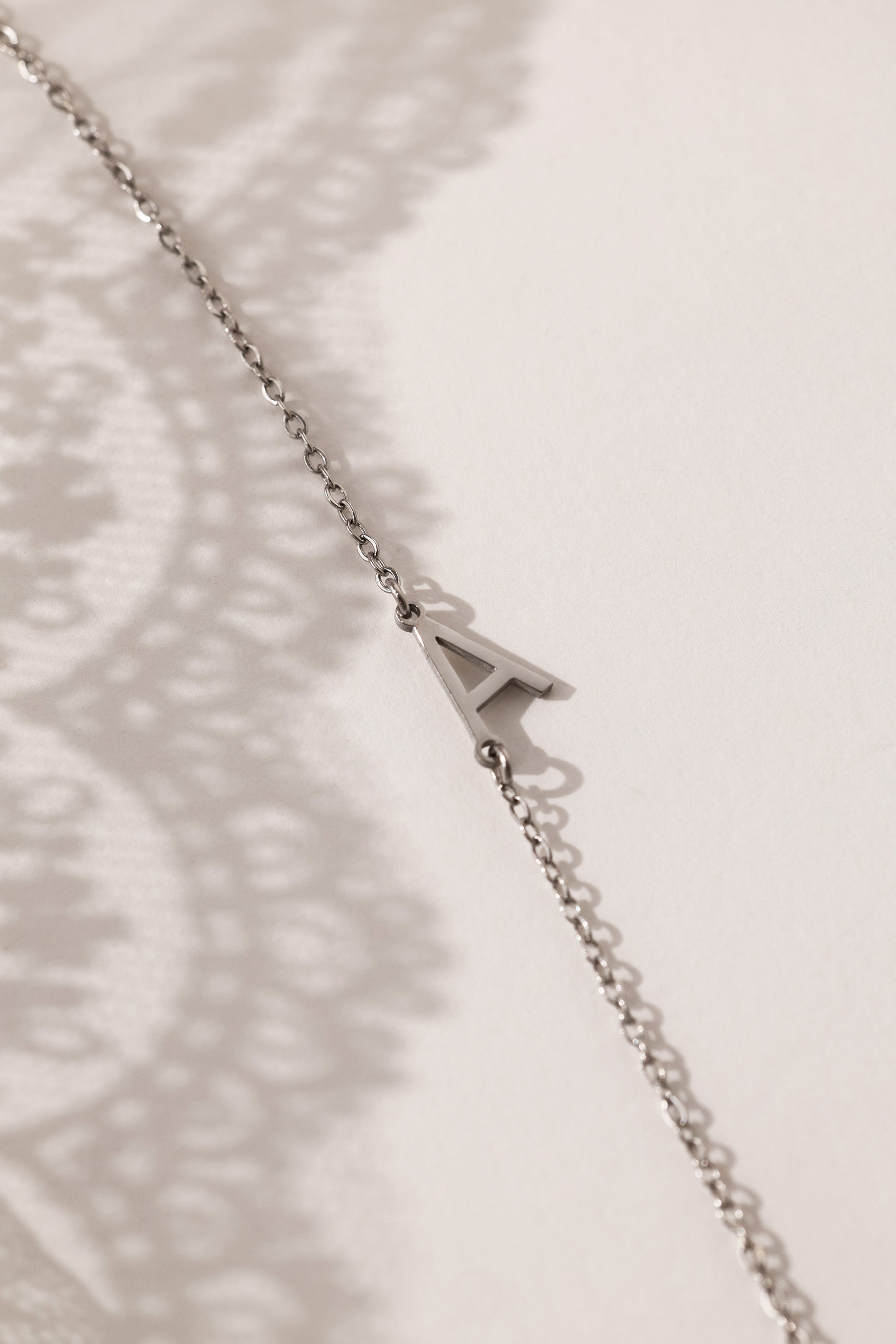 Stainless steel initial bracelet with sleek letter charm, delicate chain, minimalist look, waterproof and tarnish‑resistant, silver bracelet