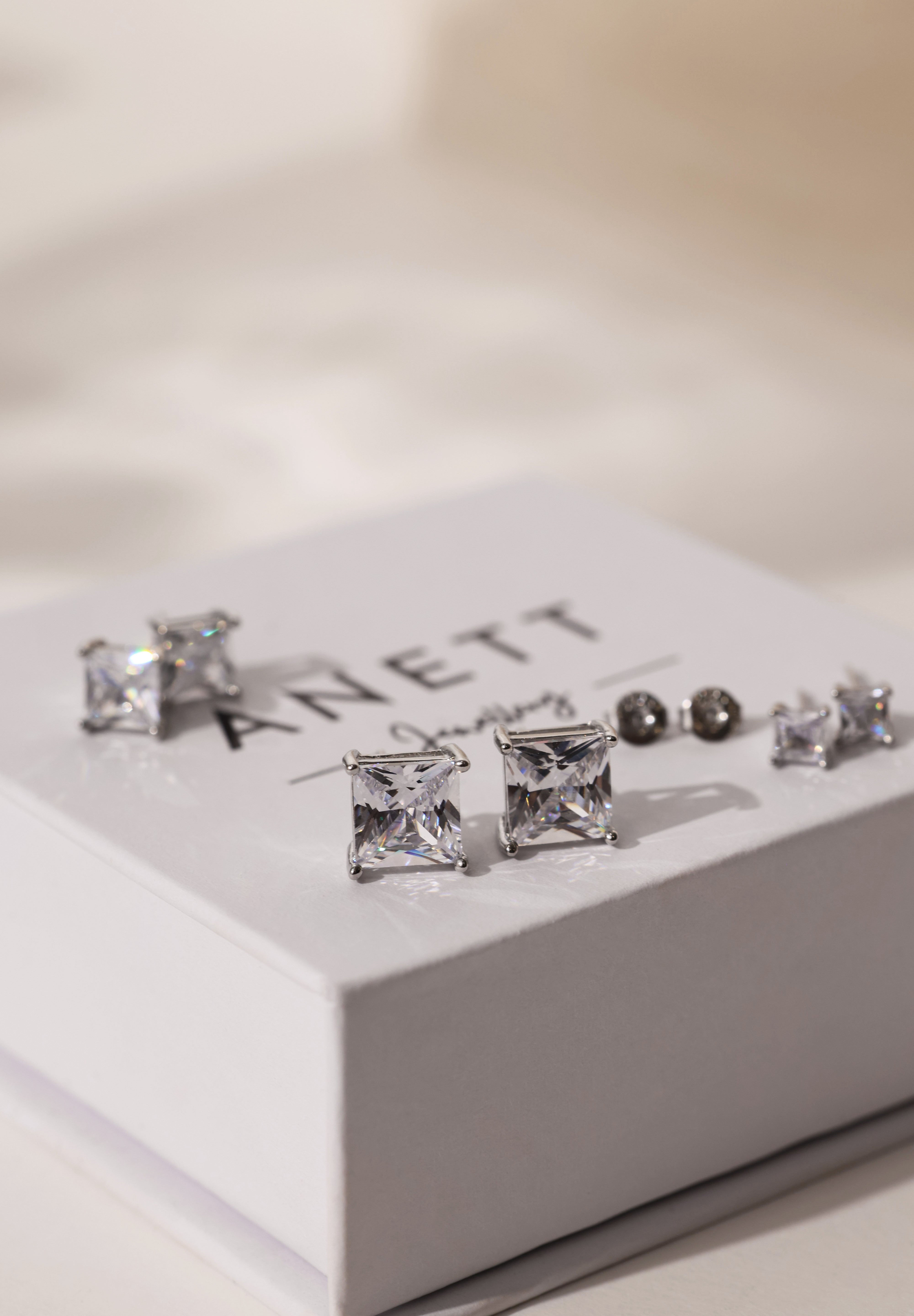 Princess cut CZ stud earrings in 9mm, 7mm, and 5mm, set in sterling silver