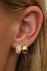 Gold Cleo huggie hoop earrings — 12mm by 8mm polished dome hoops, shown as a pair.