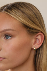 Gold Cleo huggie hoop earrings — the hinged snap closure shown open and closed.