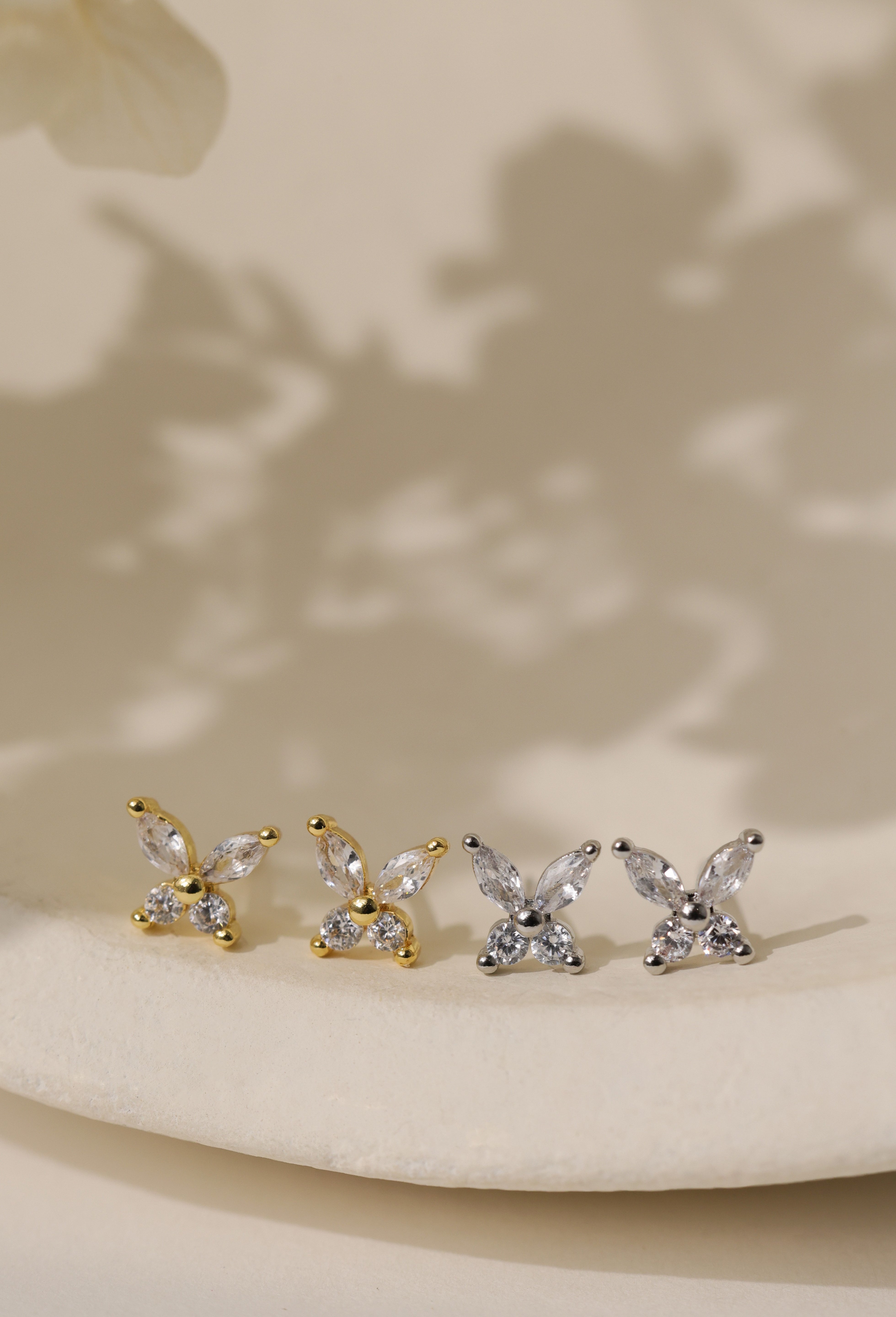 Butterfly cubic zirconia stud earrings — marquise-cut wings over round brilliant stones, 6.3mm x 7.5mm.