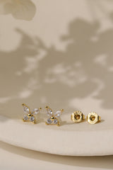 Gold-plated butterfly stud earrings set with four cubic zirconia stones, on a sterling silver base.