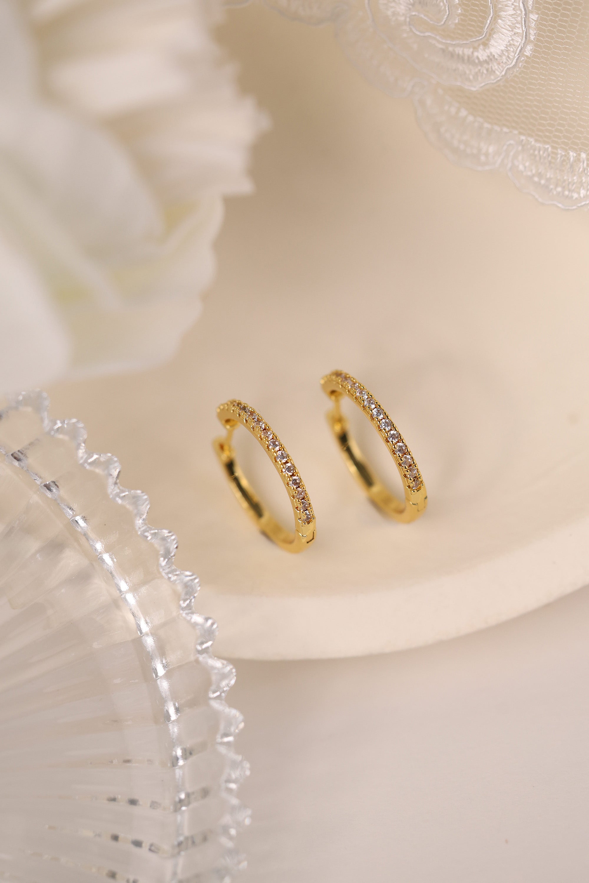25mm gold hoop earrings with cubic zirconia stones that reflect light, shown as a versatile everyday jewellery piece.”