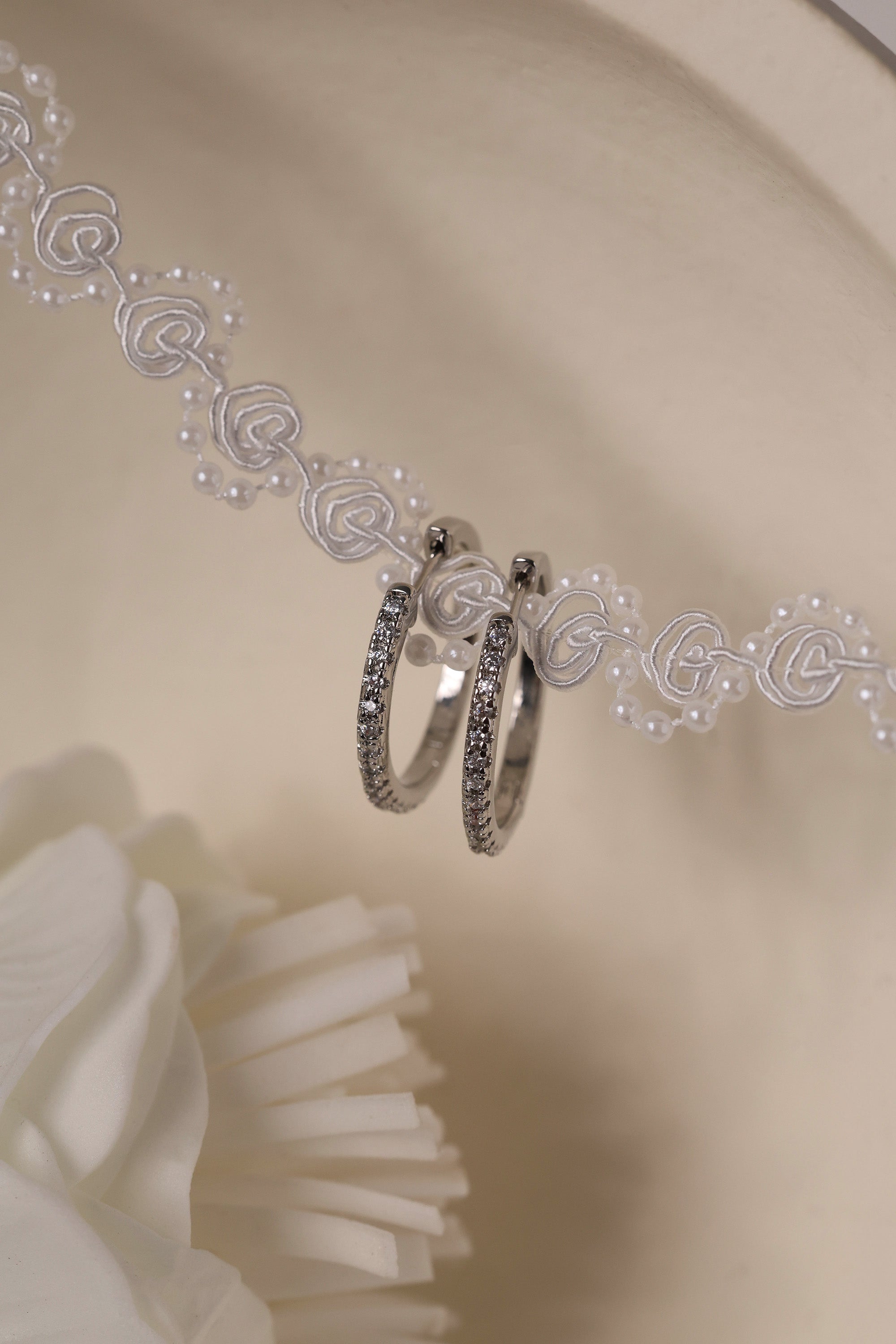 25mm silver hoop earrings with cubic zirconia stones that reflect light, shown as a versatile everyday jewellery piece.