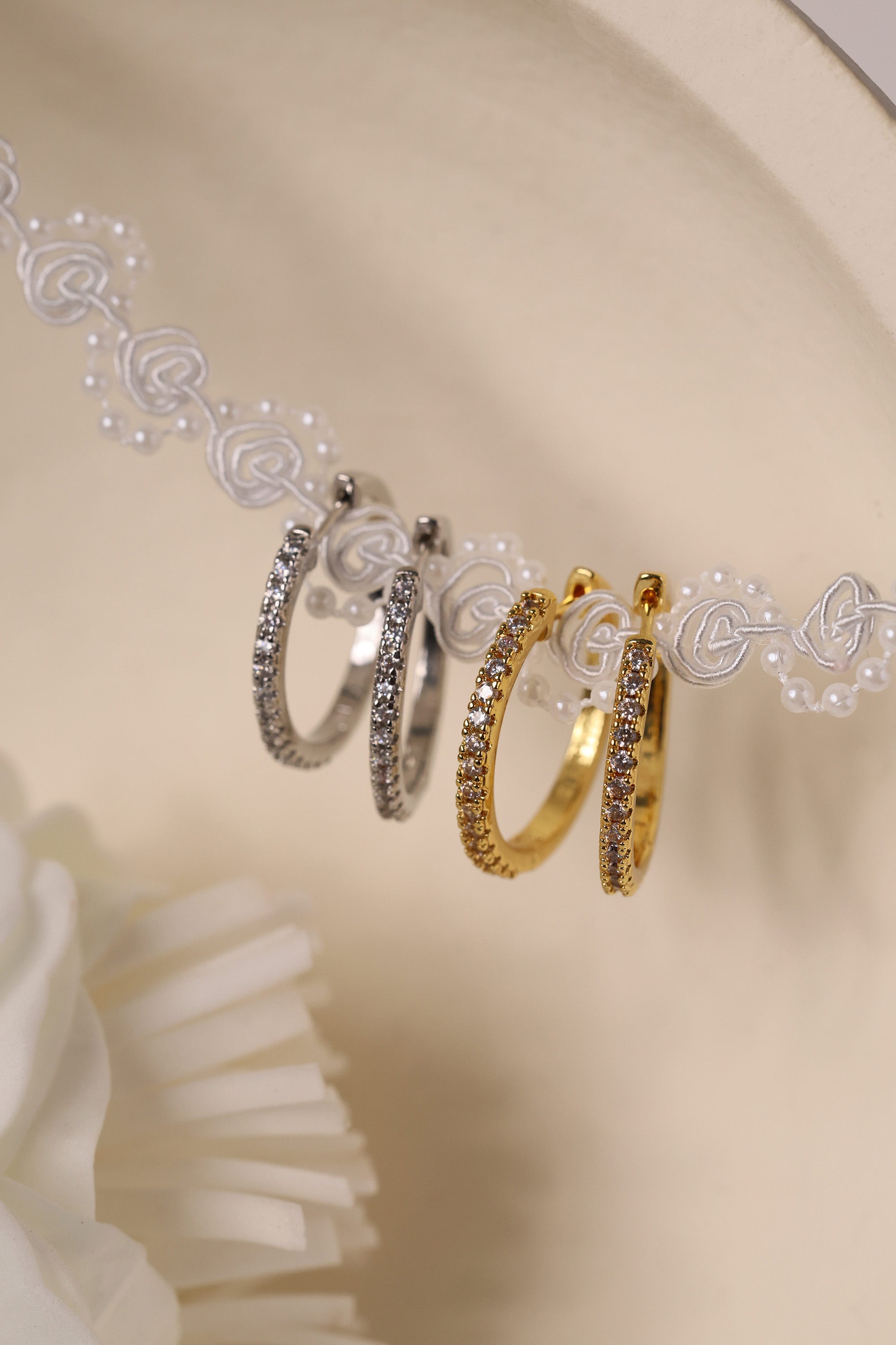 25mm silver hoop earrings with cubic zirconia stones that reflect light, shown as a versatile everyday jewellery piece.