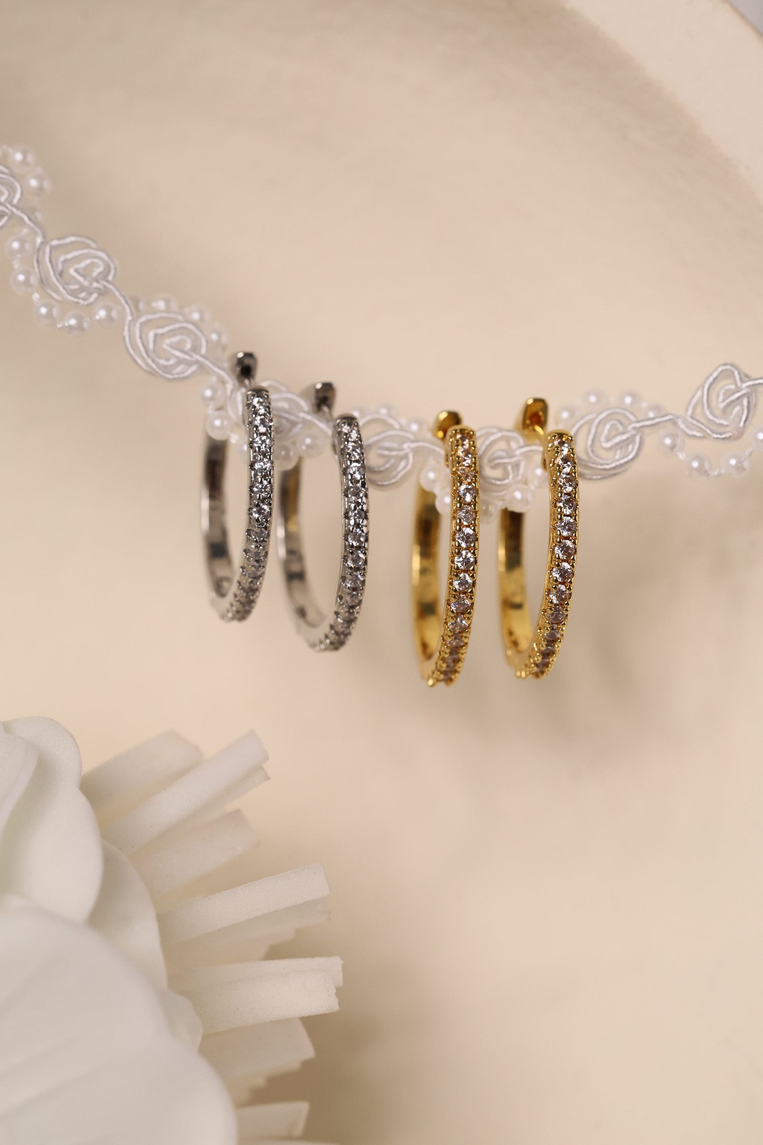 25mm silver hoop earrings with cubic zirconia stones that reflect light, shown as a versatile everyday jewellery piece.