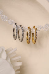 25mm silver hoop earrings with cubic zirconia stones that reflect light, shown as a versatile everyday jewellery piece.