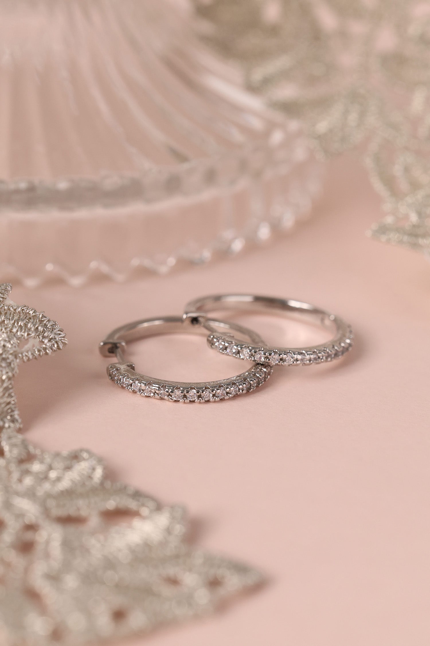 25mm silver hoop earrings with cubic zirconia stones that reflect light, shown as a versatile everyday jewellery piece.