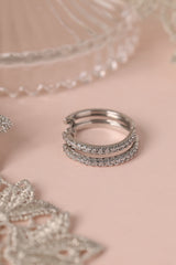 25mm silver hoop earrings with cubic zirconia stones that reflect light, shown as a versatile everyday jewellery piece.