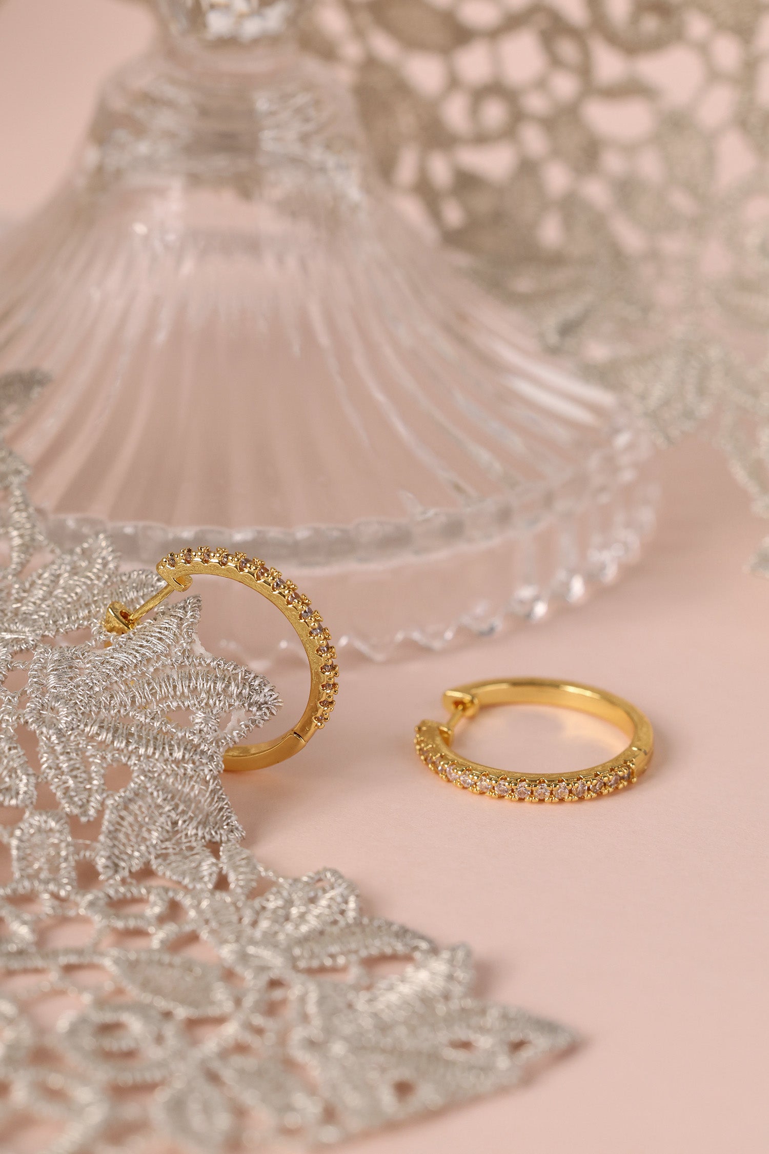25mm gold hoop earrings with cubic zirconia stones that reflect light, shown as a versatile everyday jewellery piece.”
