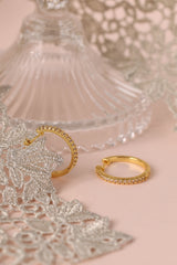 25mm gold hoop earrings with cubic zirconia stones that reflect light, shown as a versatile everyday jewellery piece.”