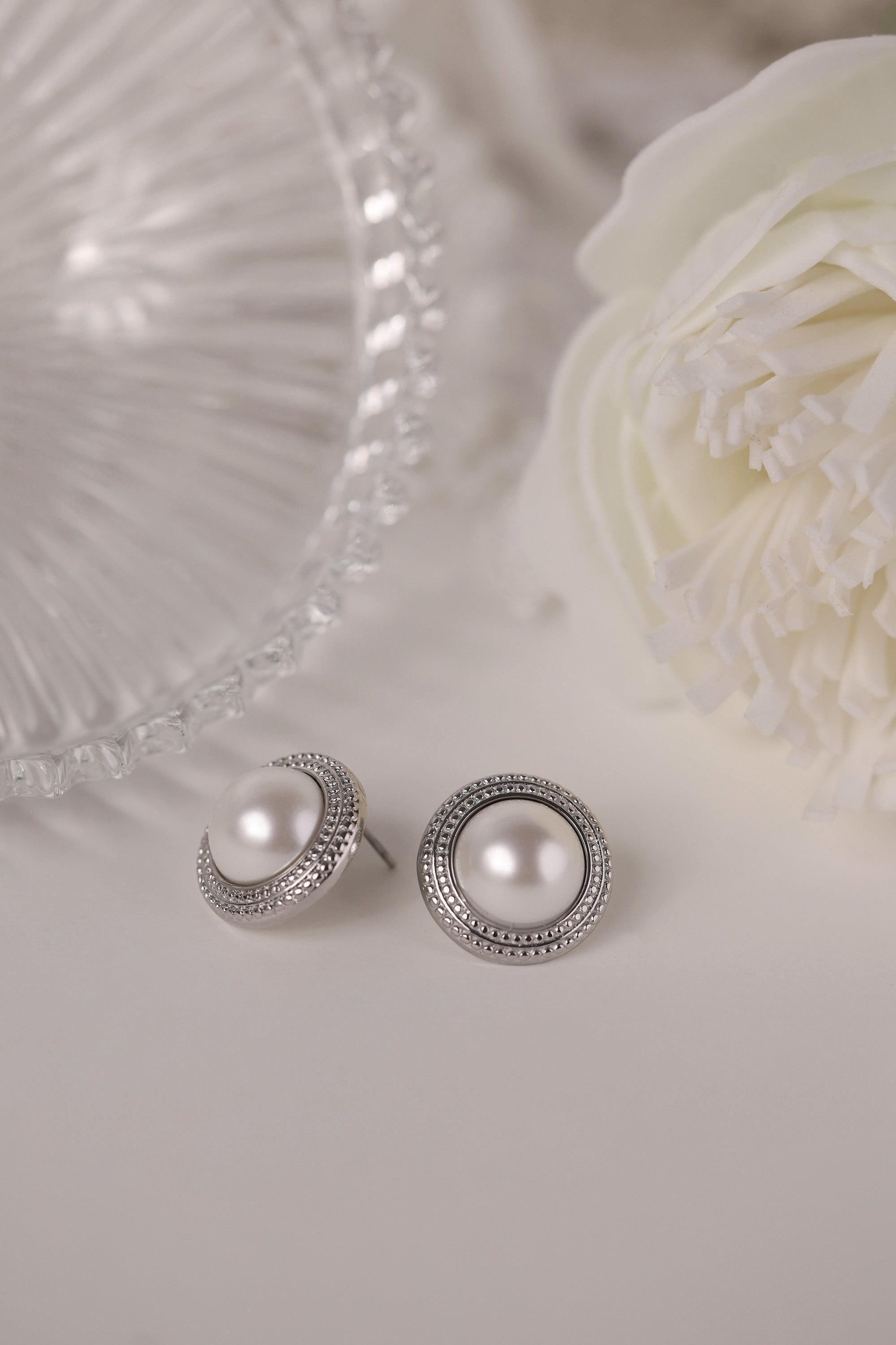 Silver beaded‑edge pearl stud earrings 