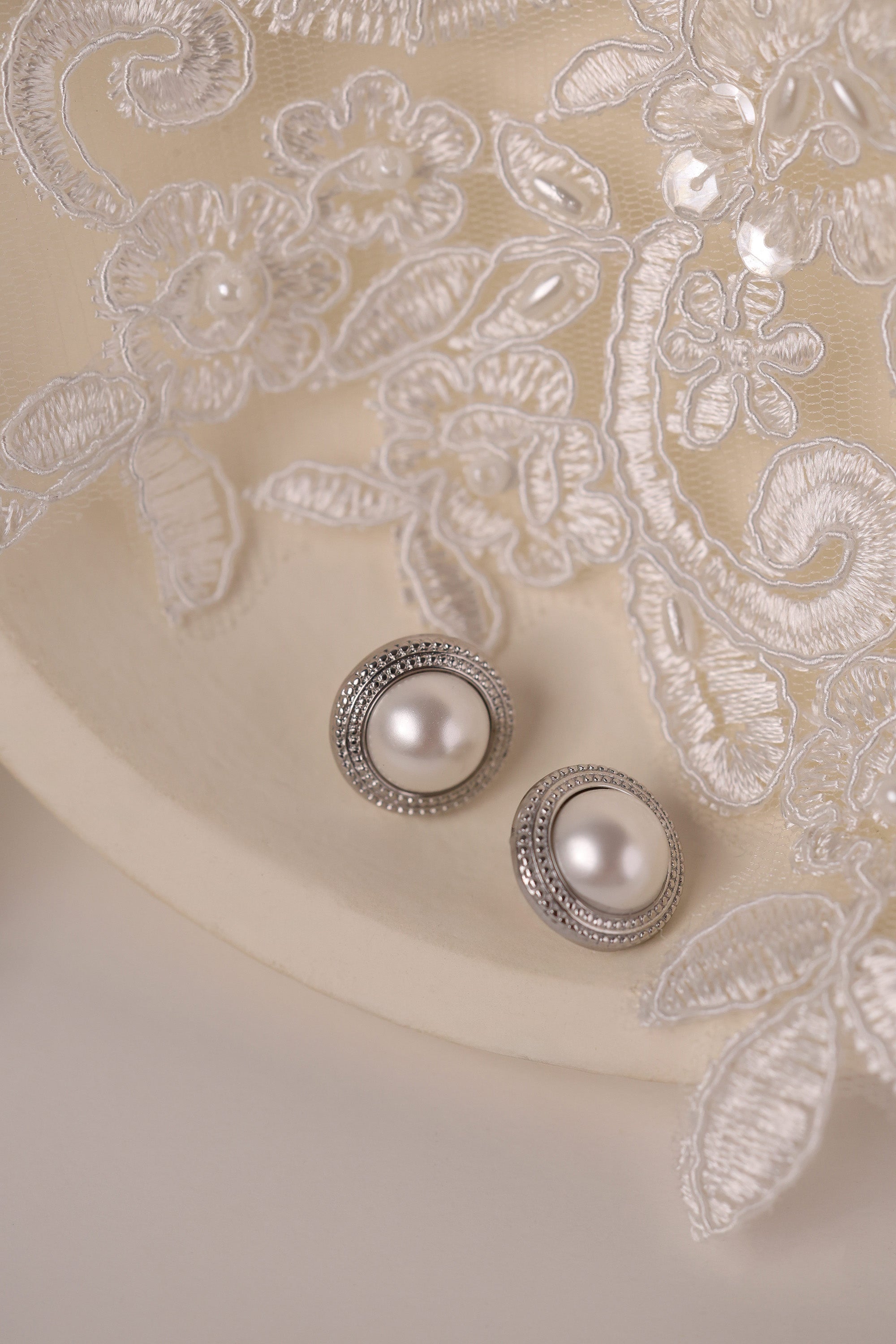 Silver beaded‑edge pearl stud earrings 