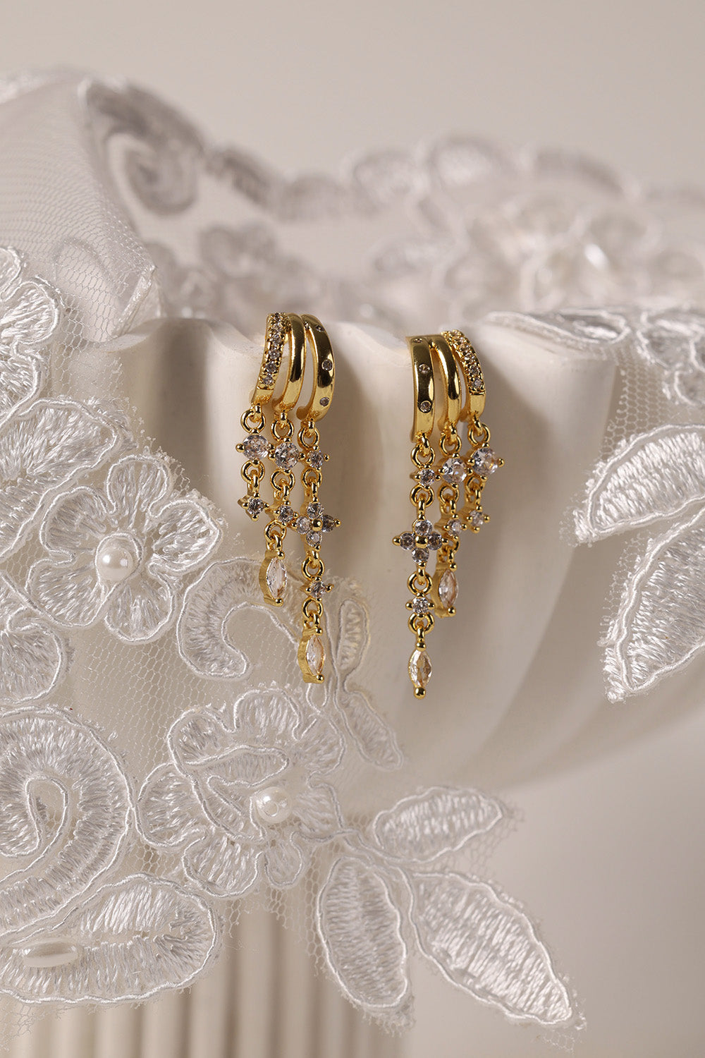 Gold triple‑drop illusion earrings with sparkling stones -Anett Jewellery