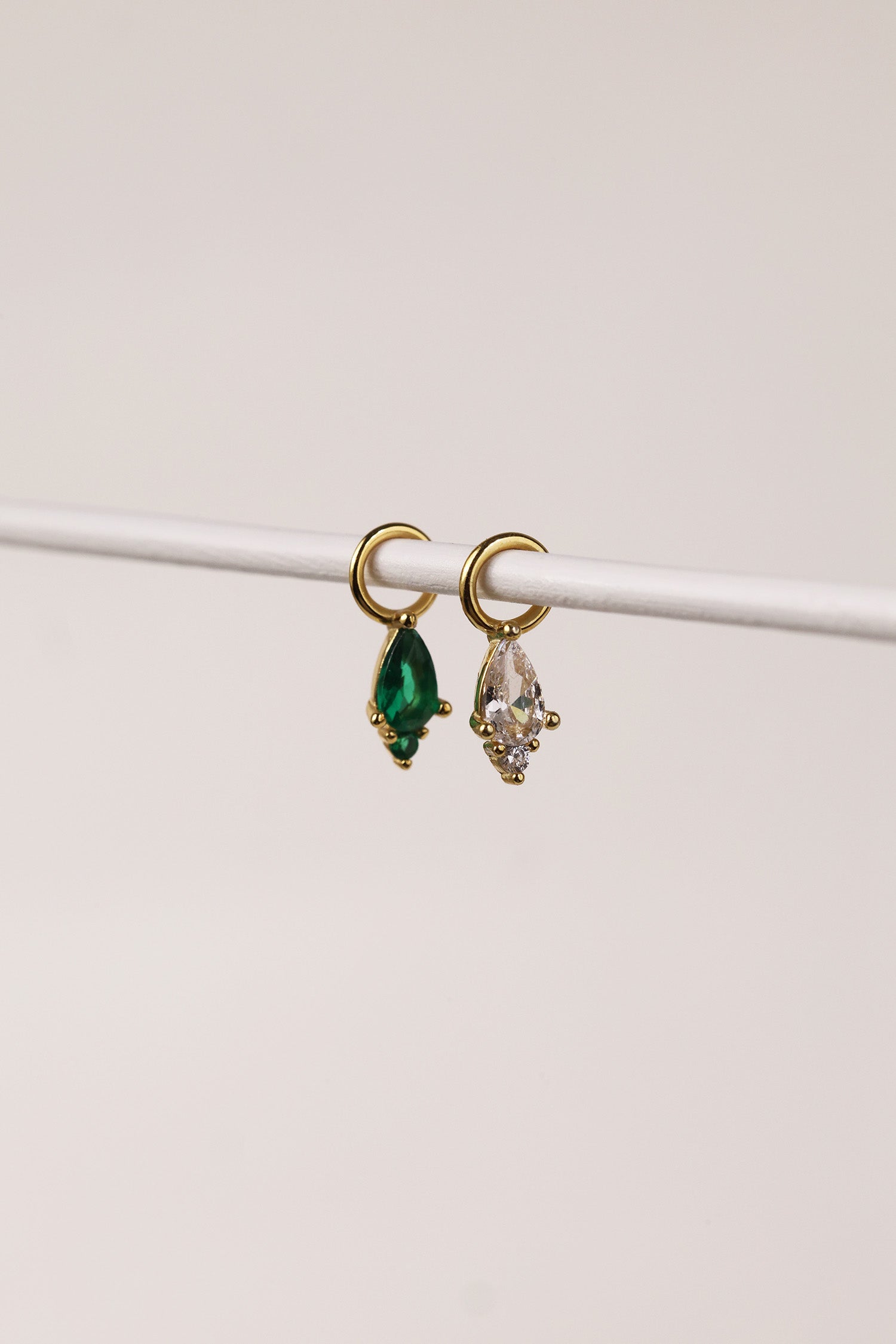 Emerald‑green teardrop cubic zirconia charm on a gold hoop, charm only, sterling silver base with 18k gold finish.