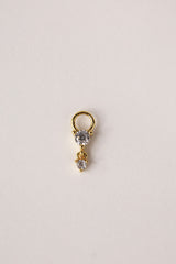 Gold hoop charm featuring two clear faceted gemstones in a tiered drop design.