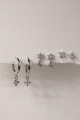 Small silver clover earring set with dangle, snowflake stud, and mini clover stud displayed on a clean background.”
