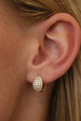 Gold Cleo Pavé huggie hoop worn on the lobe — a pavé-set cubic zirconia dome hugging the ear.