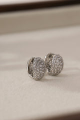Silver Cleo Pavé huggie hoop earrings shown as a pair — cubic zirconia set across the dome.