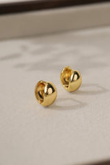 Gold Cleo Plain huggie hoop earrings as a pair — smooth polished domes with the hinge seam visible.
