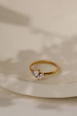 Elodie toi et moi pear ring in gold on a cream ceramic dish