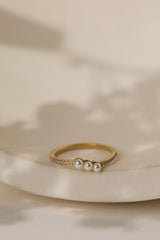 Juliette three pearl ring in gold on a cream ceramic dish