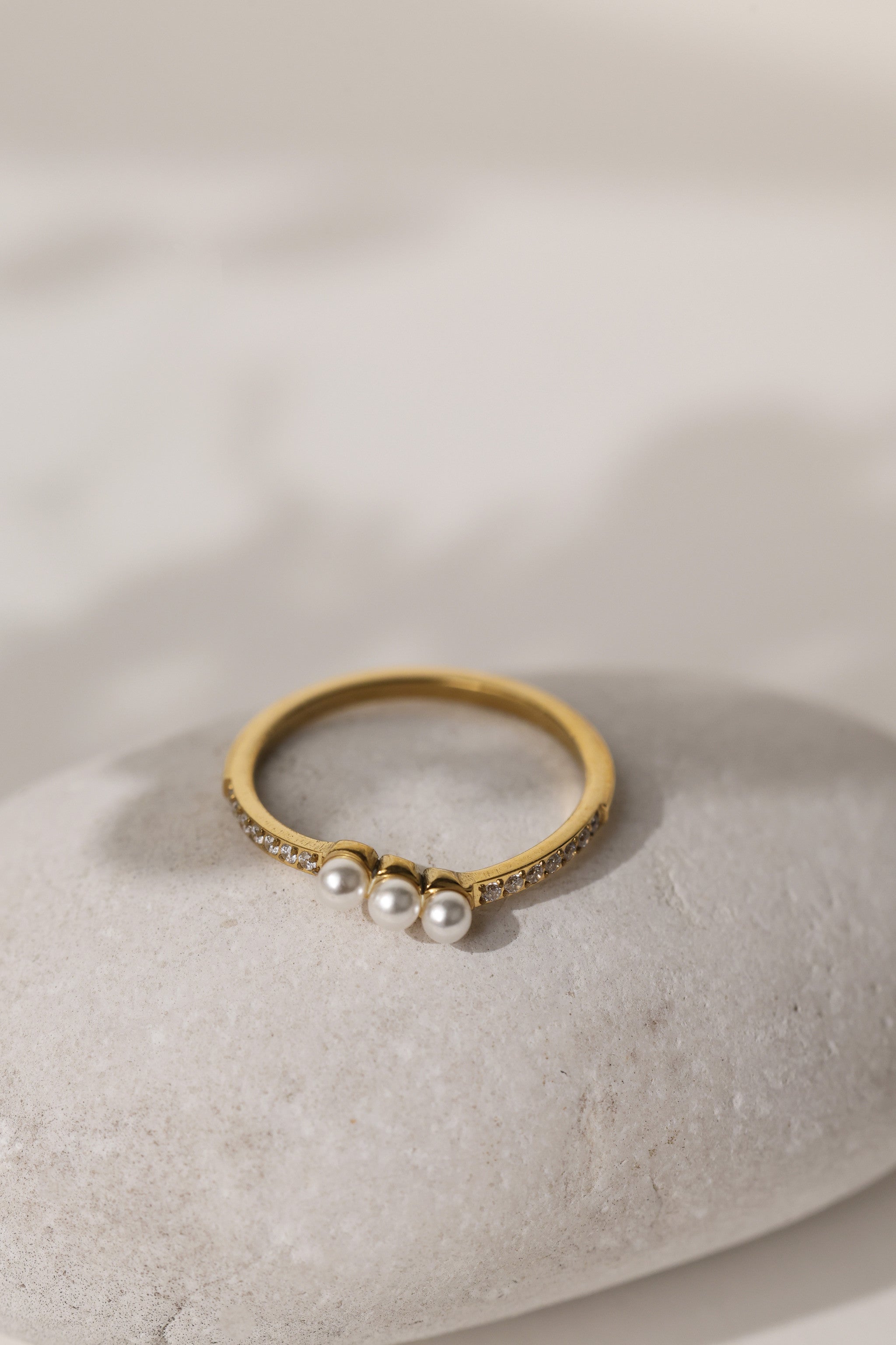 Juliette three pearl ring in gold on a pale stone, close view of the pearls