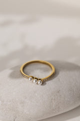 Juliette three pearl ring in gold on a pale stone, close view of the pearls
