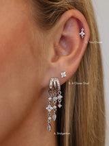 Silver triple‑drop illusion earrings with sparkling stones