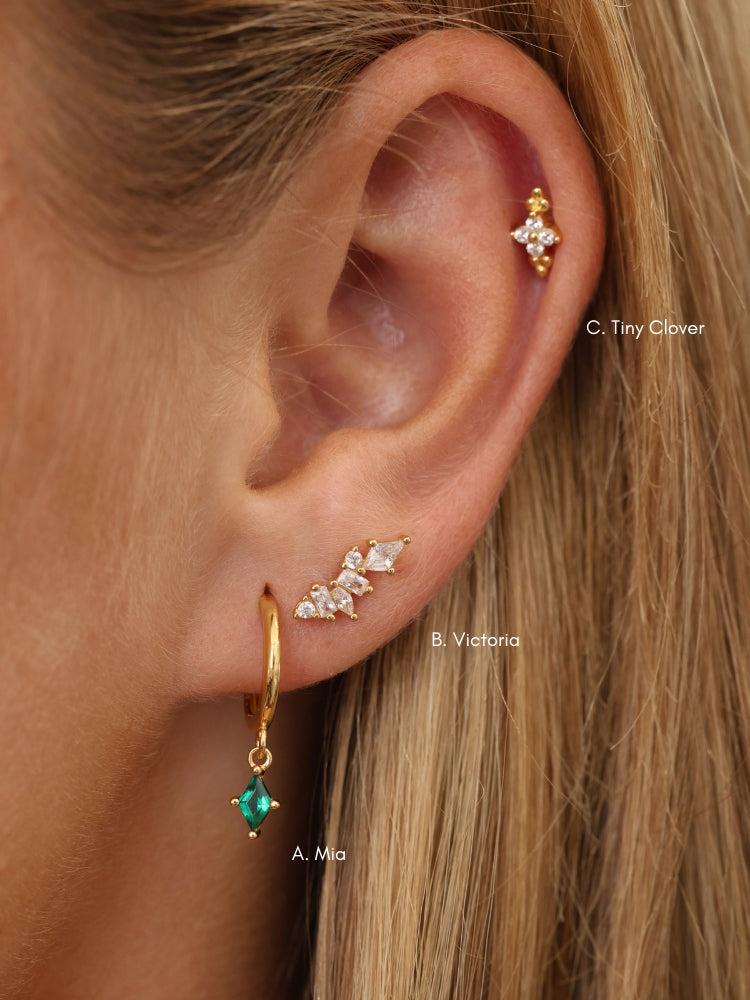 Green gemstone and clear stone sterling silver ear stack on model