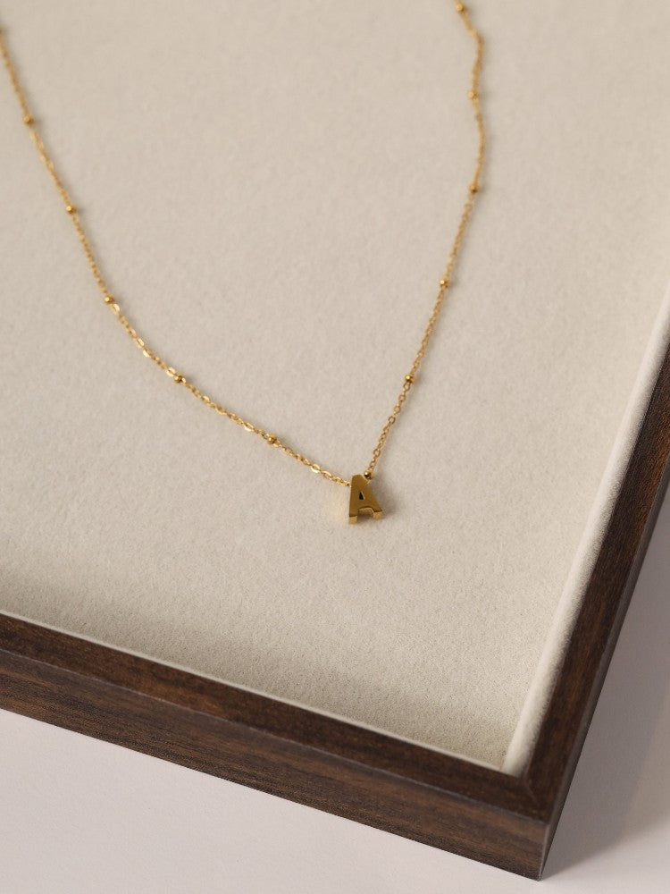Lilia Initial Gold Necklace — a personalised stainless steel necklace featuring an elegant initial charm and birthstone option. Waterproof, tarnish‑resistant and perfect for gifting. A meaningful everyday piece designed for effortless elegance