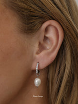 Waterproof pavé hoop earrings with natural freshwater pearl drops. Available in 10mm, 12mm, and 14mm. Tarnish‑resistant, elegant, and perfect for everyday wear.