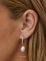 Waterproof pavé hoop earrings with natural freshwater pearl drops. Available in 10mm, 12mm, and 14mm. Tarnish‑resistant, elegant, and perfect for everyday wear.